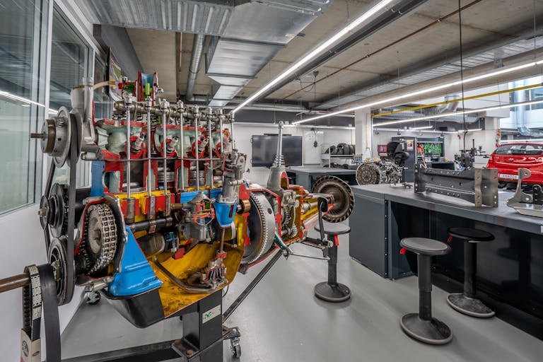 Interior of a modern workshop featuring detailed automotive machinery and equipment.