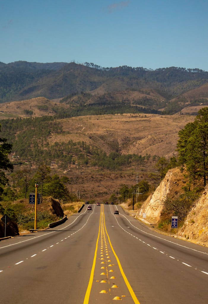 A scenic highway stretching through the hilly landscape of Amarateca, Honduras.