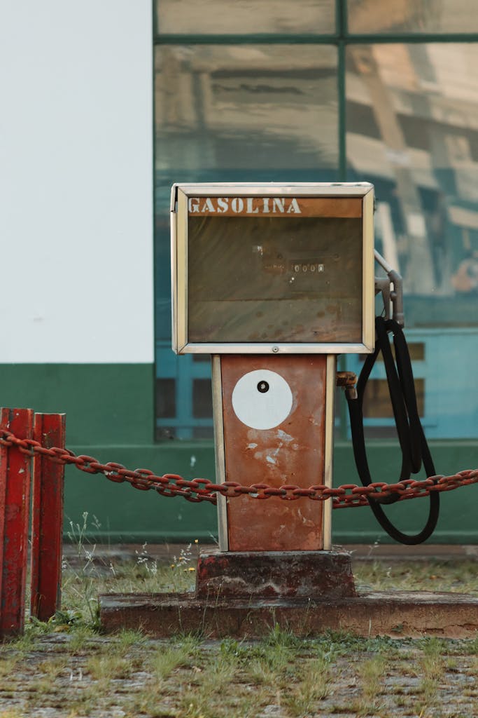 Explore the charm of an old vintage gas pump at a deserted station. Perfect for nostalgic themes.