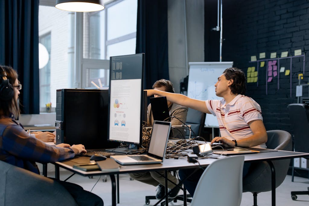 Imagen actual: Group of young professionals working on software development in a creative indoor workspace.