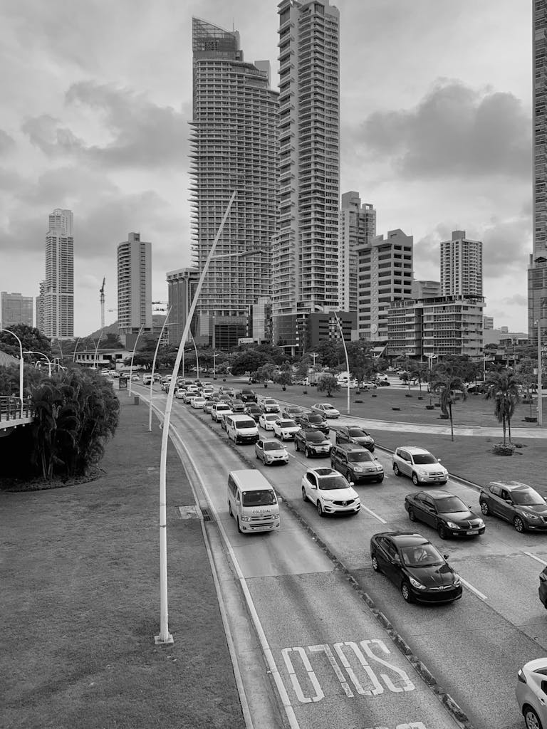 Urban traffic flows beneath towering skyscrapers in a bustling cityscape.